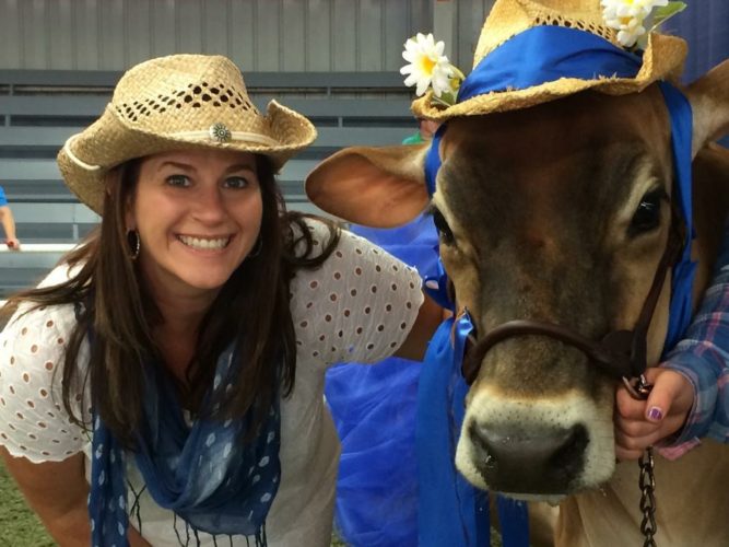 Amy Shuler-Goodwin poses with a cow at the West Virginia State Fair.
